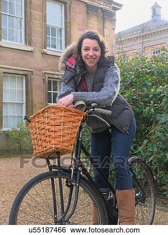 Female university student on bicycle View Large Photo Image Stock Photograph - Female university student on bicycle. Fotosearch