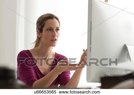 Frustrated woman using computer View Large Photo Image Stock Photography - Frustrated woman using computer. Fotosearch