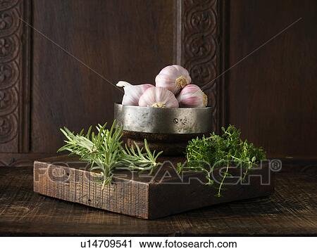 Garlic, rosemary and thyme on rustic wooden board View Large Photo Image Stock Image - Garlic, rosemary and thyme on rustic wooden board. Fotosearch