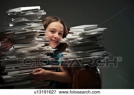 Girl holding pile of books View Large Photo Image Stock Photo - Girl holding pile of books. Fotosearch