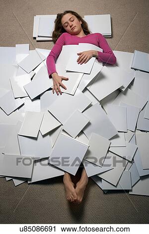 Girl lying on floor asleep covered with pieces of paper View Large Photo Image Stock Image - Girl lying on floor asleep covered with pieces of paper. Fotosearch