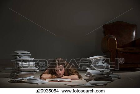 Girl lying on front reading book View Large Photo Image Picture - Girl lying on front reading book. Fotosearch