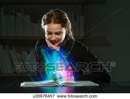 Girl reading book with multicoloured lights View Large Photo Image Stock Photo - Girl reading book with multicoloured lights. Fotosearch