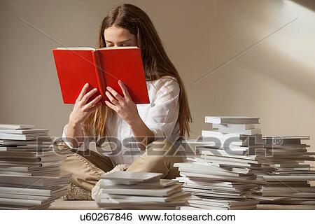 Girl sitting on floor reading book View Large Photo Image Stock Photograph - Girl sitting on floor reading book. Fotosearch