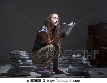 Girl sitting on pile of books reading View Large Photo Image Stock Image - Girl sitting on pile of books reading. Fotosearch