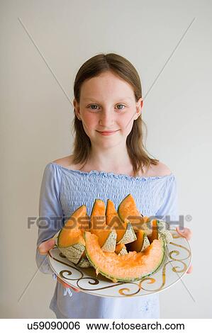 Girl with slices of melon View Large Photo Image Stock Photograph - Girl with slices of melon. Fotosearch