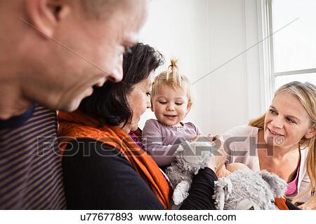 Grandmother holding toddler granddaughter with parents View Large Photo Image Stock Image - Grandmother holding toddler granddaughter with parents. Fotosearch