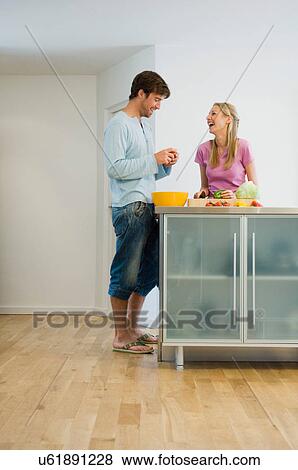 Happy young couple in kitchen View Large Photo Image Stock Photo - Happy young couple in kitchen. Fotosearch