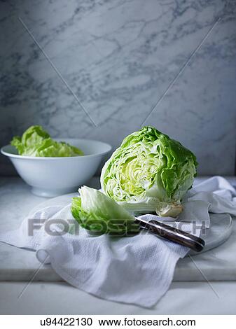 Stock Image - Iceberg lettuce on white tea towel. Fotosearch