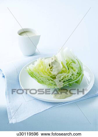 Stock Photograph - Iceberg lettuce with blue cheese dressing. Fotosearch