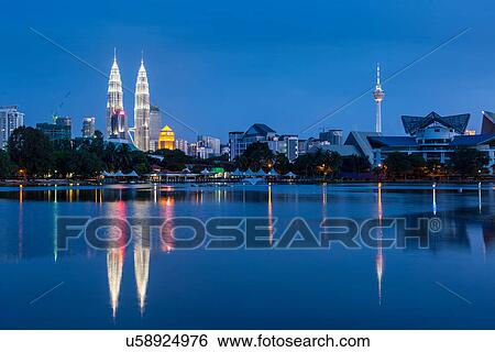 Stock Photograph - Kuala Lumpur cityscape at night including Petronas Twin Towers over Titiwangsa Lake, Malaysia. Fotosearch