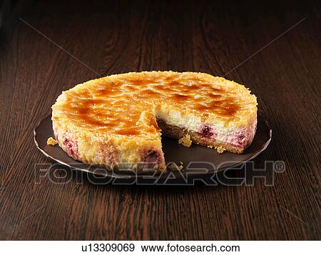 Lemon and raspberry brulee cheesecake on dark brown plate and surface View Large Photo Image Stock Photo - Lemon and raspberry brulee cheesecake on dark brown plate and surface. Fotosearch