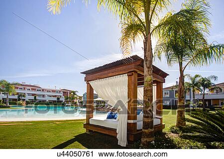 Stock Image - Luxury sun lounger at holiday resort. Fotosearch