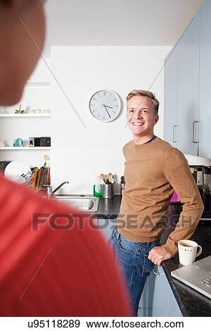 Stock Photo - Male student in kitchen. Fotosearch