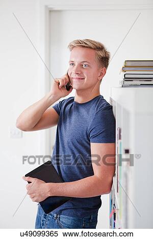 Male student on cell phone View Large Photo Image Stock Photography - Male student on cell phone. Fotosearch
