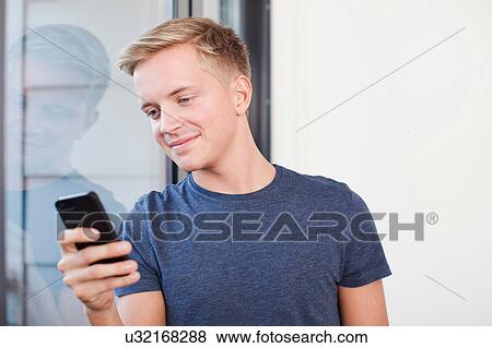 Male student using cell phone View Large Photo Image Stock Photo - Male student using cell phone. Fotosearch