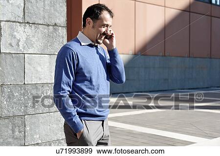 Mature businessman using cellphone outdoors View Large Photo Image Stock Photo - Mature businessman using cellphone outdoors. Fotosearch