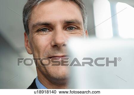 Mature businessman using digital tablet View Large Photo Image Stock Image - Mature businessman using digital tablet. Fotosearch
