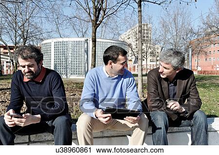Mature businessmen using digital tablet and cellphone outside View Large Photo Image Stock Image - Mature businessmen using digital tablet and cellphone outside. Fotosearch