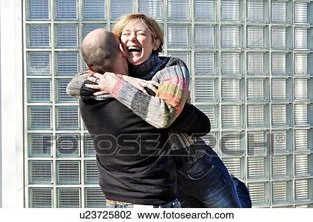 Stock Image - Mature couple embracing outside. Fotosearch