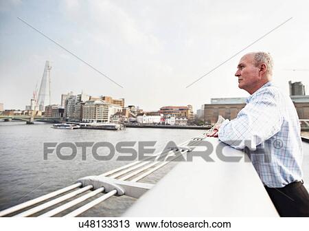 Mature man leaning on Millennium Bridge, London, England, UK View Large Photo Image Stock Image - Mature man leaning on Millennium Bridge, London, England, UK. Fotosearch