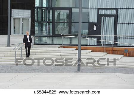 Mature man standing outside of office block View Large Photo Image Stock Photography - Mature man standing outside of office block. Fotosearch