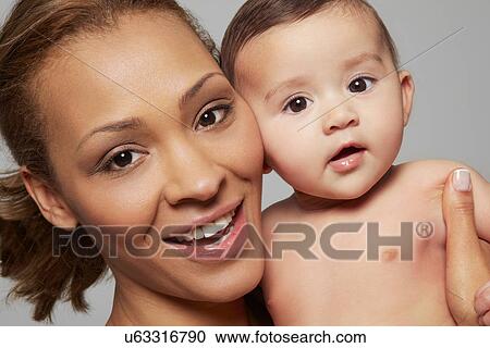 Stock Image - Mother and her baby girl. Fotosearch