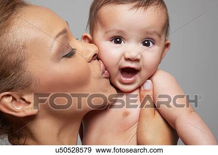 Mother kissing her baby girl View Large Photo Image Stock Photo - Mother kissing her baby girl. Fotosearch