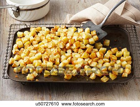 Parmentier potatoes on baking sheet and wire rack. Maris Piper potatoes roasted in garlic and rosemary butter View Large Photo Image Stock Image - Parmentier potatoes on baking sheet and wire rack. Maris Piper potatoes roasted in garlic and rosemary butter. Fotosearch