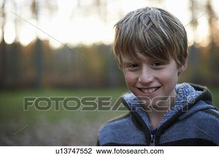 Stock Image - Portrait of boy in forest. Fotosearch