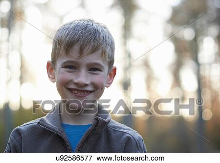 Stock Photo - Portrait of boy in forest. Fotosearch