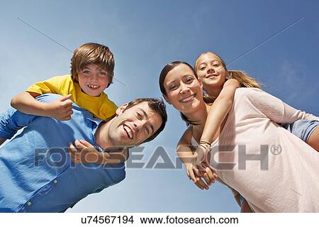 Portrait of family with two children from below View Large Photo Image Picture - Portrait of family with two children from below. Fotosearch