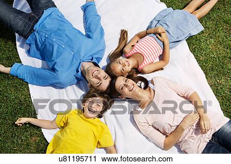 Stock Image - Portrait of family with two children from overhead. Fotosearch