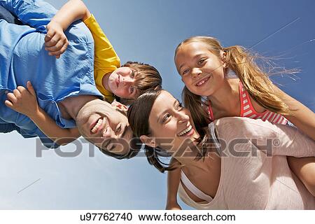Portrait of family with two children from below View Large Photo Image Stock Image - Portrait of family with two children from below. Fotosearch