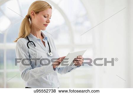Portrait of female doctor with stethoscope and digital tablet View Large Photo Image Stock Photo - Portrait of female doctor with stethoscope and digital tablet. Fotosearch