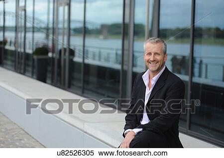 Portrait of mature man smiling in financial district View Large Photo Image Stock Photography - Portrait of mature man smiling in financial district. Fotosearch