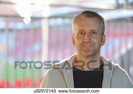 Stock Image - Portrait of mature man smiling, indoors. Fotosearch