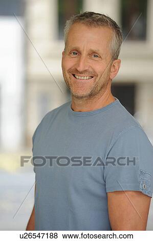 Stock Photo - Portrait of mature man smiling, indoors. Fotosearch