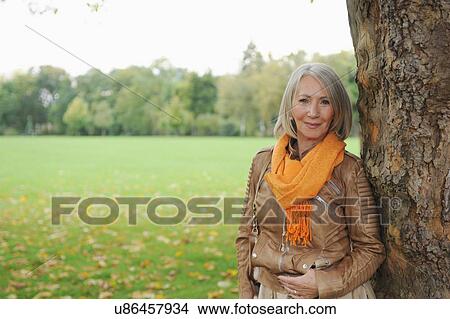 Portrait of senior woman in park View Large Photo Image Picture - Portrait of senior woman in park. Fotosearch