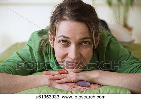 Portrait of woman with hands on chin looking at camera View Large Photo Image Stock Image - Portrait of woman with hands on chin looking at camera. Fotosearch