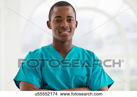 Picture - Portrait of young man wearing surgical scrubs. Fotosearch