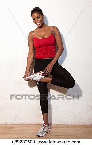 Portrait of young woman in gym View Large Photo Image Stock Photo - Portrait of young woman in gym. Fotosearch