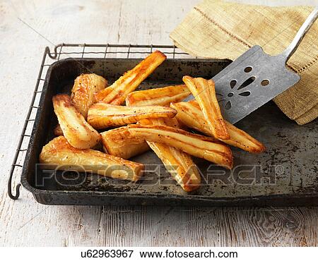 Roast parsnips on baking tray and wire rack View Large Photo Image Stock Photo - Roast parsnips on baking tray and wire rack. Fotosearch