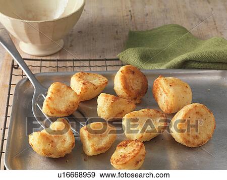 Roast potatoes on baking tray and wire rack View Large Photo Image Stock Photo - Roast potatoes on baking tray and wire rack. Fotosearch
