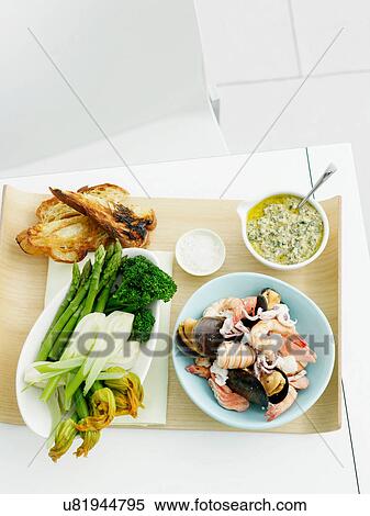 Salsa verde, mixed seafood, fennel, zucchini, asparagus, broccolini and bread View Large Photo Image Stock Photography - Salsa verde, mixed seafood, fennel, zucchini, asparagus, broccolini and bread. Fotosearch