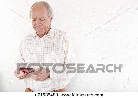Senior man holding digital camera View Large Photo Image Stock Image - Senior man holding digital camera. Fotosearch