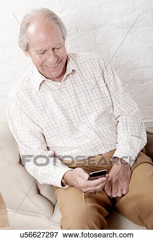 Senior man using smartphone View Large Photo Image Stock Photo - Senior man using smartphone. Fotosearch