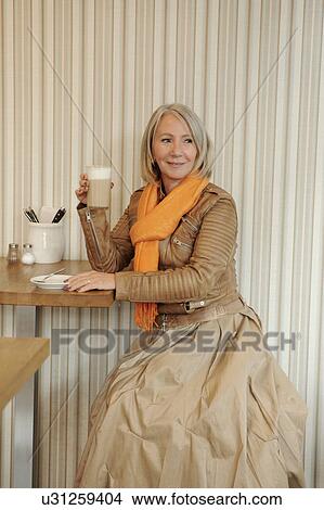 Senior woman sitting on coffee shop View Large Photo Image Picture - Senior woman sitting on coffee shop. Fotosearch