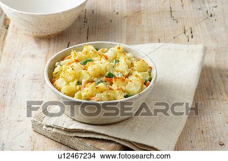 Small vegetable bake consisting of potatoes, green beans and carrots in white bowl View Large Photo Image Picture - Small vegetable bake consisting of potatoes, green beans and carrots in white bowl. Fotosearch