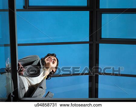 Smart lady in corporate environment with mobile phone View Large Photo Image Stock Image - Smart lady in corporate environment with mobile phone. Fotosearch